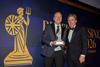 Ken McMeikan, CEO of Moto Hospitality, recieves the CEO of the Year Award from British Business Awards host, Rob Brydon