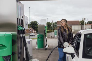 Getty woman filling up car