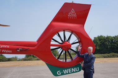 Ascona Group CEO Darren Briggs alongside Branded Wales Air Ambulance Helicopter