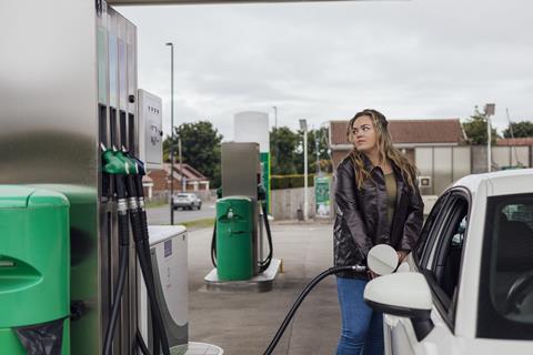 Getty woman filling up car