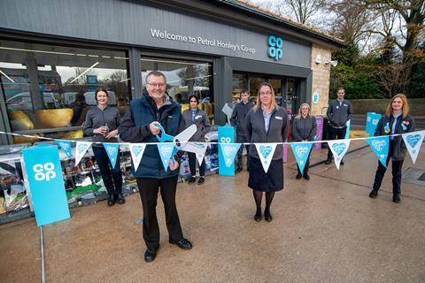 Ian Gooch from the Full Life Church food bank performs the ribbon cutting