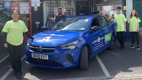 Tommy Sandhu and students with an electric vehicle funded by Highways England