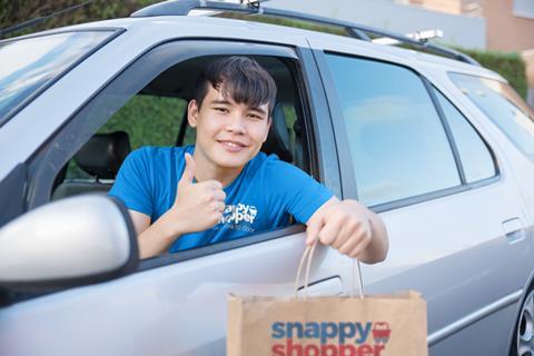 Male driver hanging out car window with bag copy