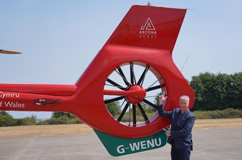 Ascona Group CEO Darren Briggs alongside Branded Wales Air Ambulance Helicopter