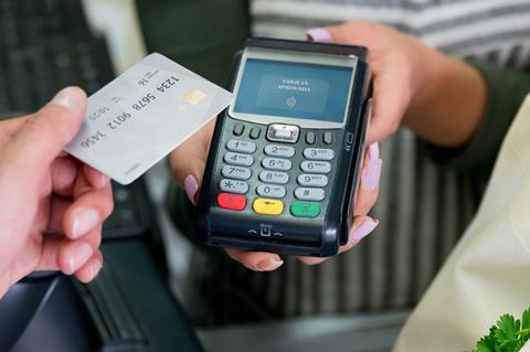 Card payment supermarket cashier till checkout GettyImages-1349881366