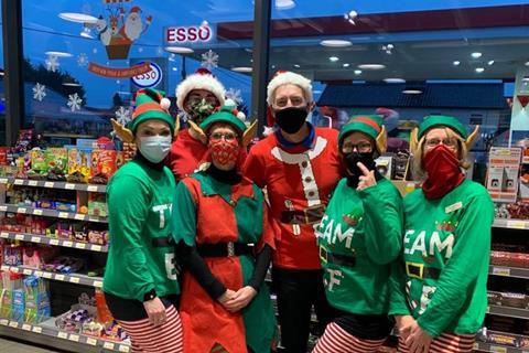 FT - Staff at Esso Harleston in Norfolk bringing some festive cheer to customers